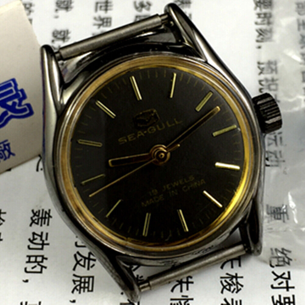 27mm golden round case ladies watch with black dial, manual mechanical movement by Tianjin Seagull.