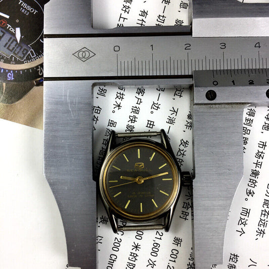 27mm golden round case ladies watch with black dial, manual mechanical movement by Tianjin Seagull.