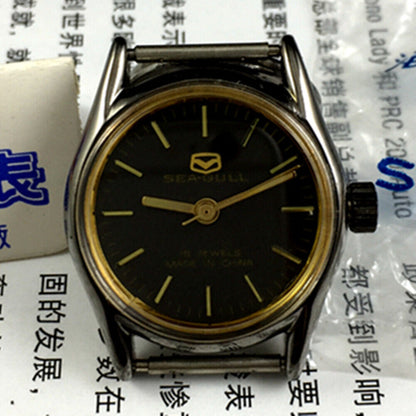 27mm golden round ladies watch with black dial, manual mechanical movement by Tianjin Seagull, elegant design.