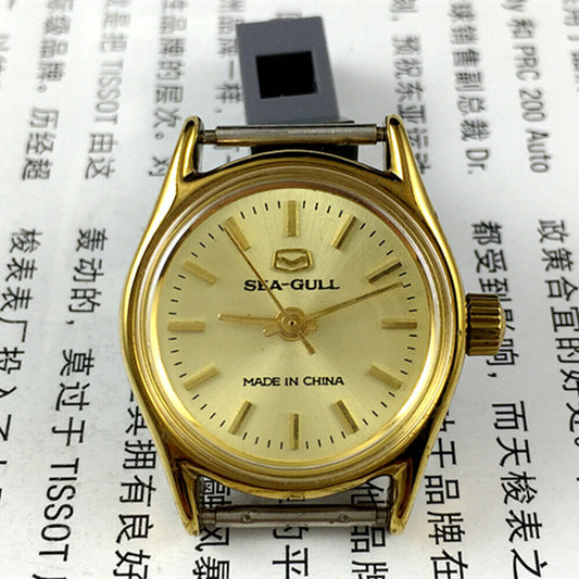 Elegant 26mm Seagull ladies watch with golden round case and manual mechanical movement, featuring a stylish band.
