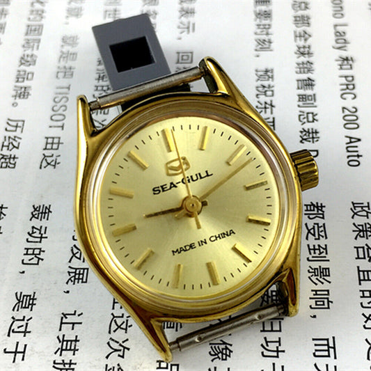 Elegant 26mm Seagull ladies watch with golden round case and manual mechanical movement, featuring a stylish band.