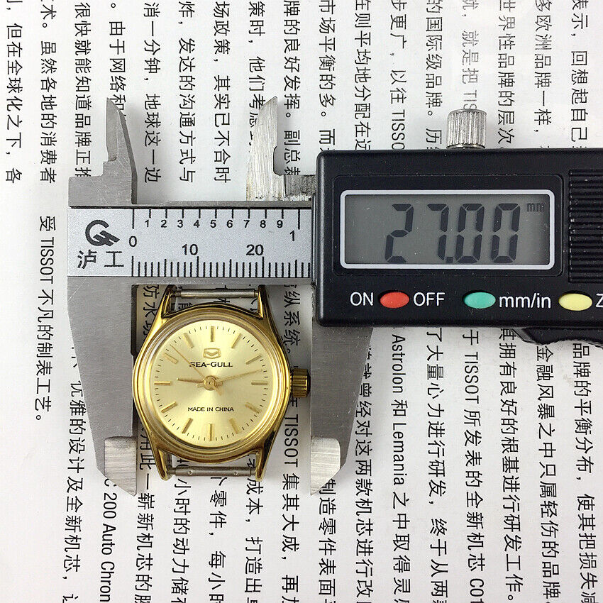 Seagull 26mm ladies watch with golden round case, manual movement, and elegant band for stylish wear.