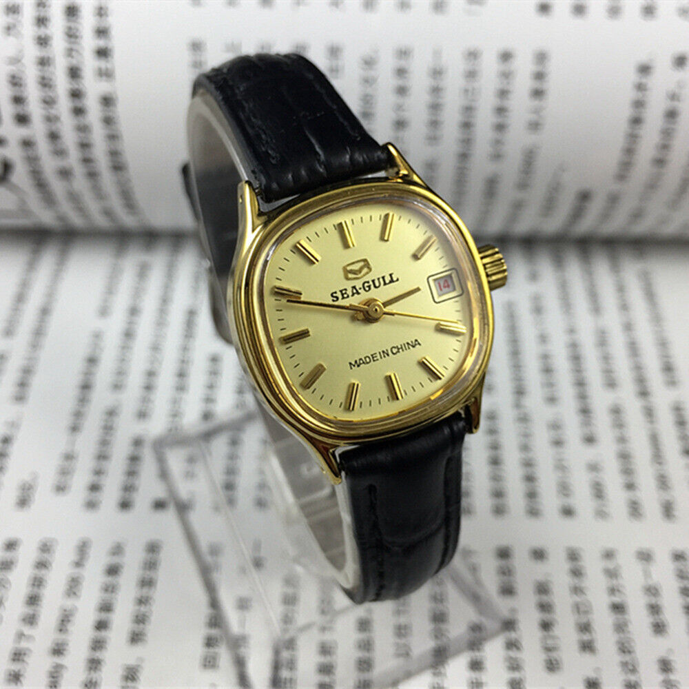 Elegant Seagull ladies watch with golden square case, nail markers, and single calendar display, manual mechanical movement.