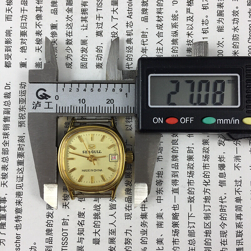 Seagull ladies watch featuring a gold square case, nail markers, single calendar, and manual mechanical movement.