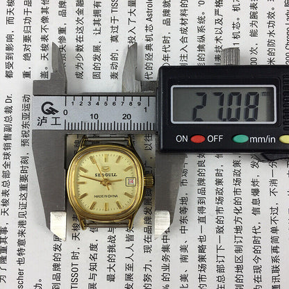Seagull ladies watch featuring a gold square case, nail markers, single calendar, and manual mechanical movement.