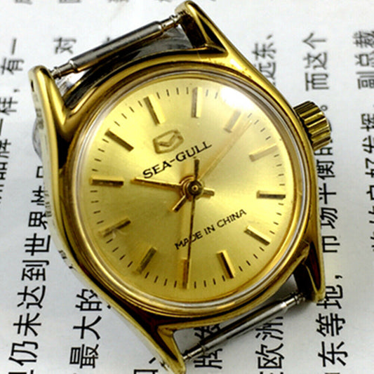 27mm round gold-tone Tianjin Seagull ladies watch with manual mechanical movement and elegant nail hour markers.