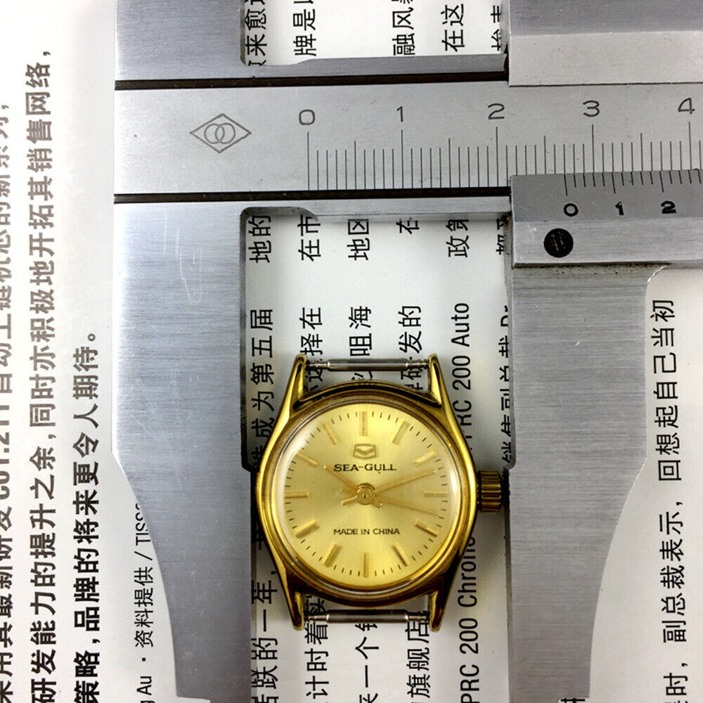 27mm gold-tone Tianjin Seagull ladies watch with manual movement and elegant nail hour markers.