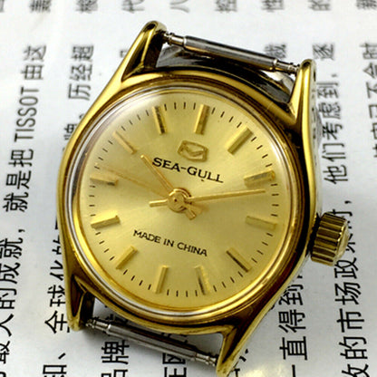 27mm Tianjin Seagull gold-tone ladies watch with manual movement and elegant nail hour markers.