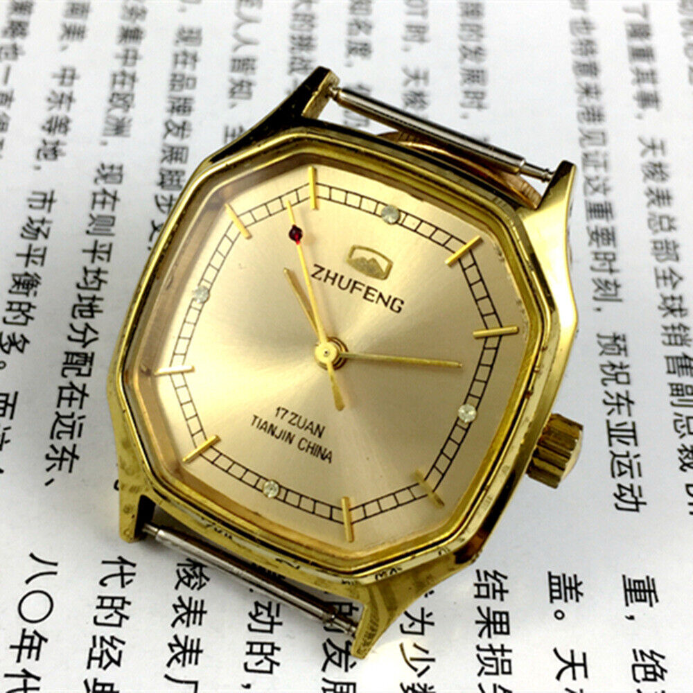 Golden octagonal 34mm Zhufeng Tianjin watch with manual mechanical movement and detailed nail design.