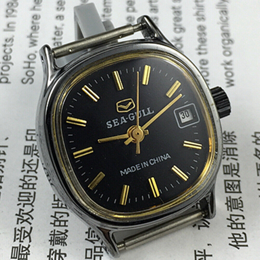 26mm Seagull manual mechanical lady watch with black case, golden nail markers, single calendar display.