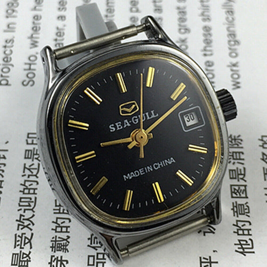 26mm Seagull manual mechanical lady watch with black case, golden nail markers, single calendar display.