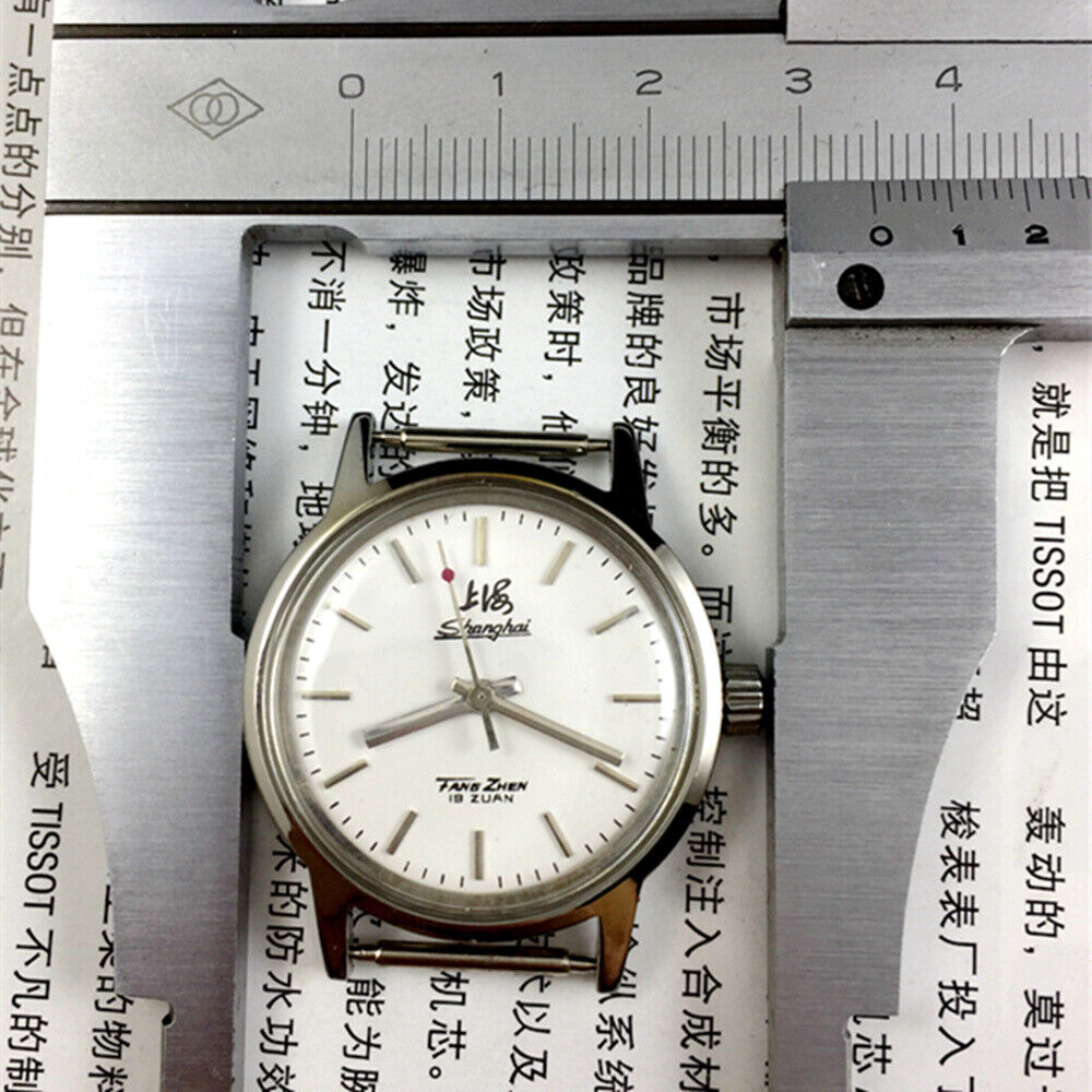 Silver 32mm Shanghai Factory manual mechanical watch with silver case, nail markers, and classic style.