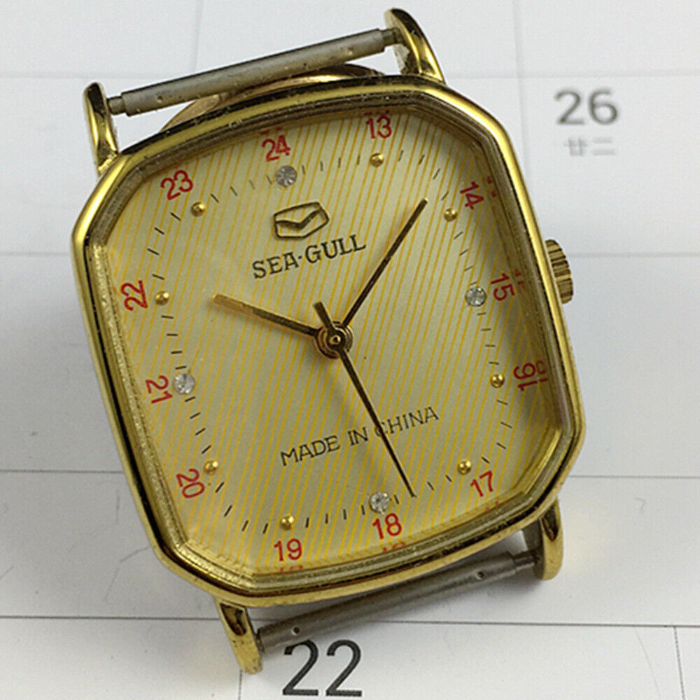 28mm golden octagonal case Tianjin Seagull watch with manual mechanical movement and elegant golden dial.