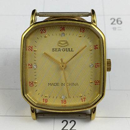 28mm golden octagonal case Tianjin Seagull watch with manual mechanical movement and elegant golden dial.