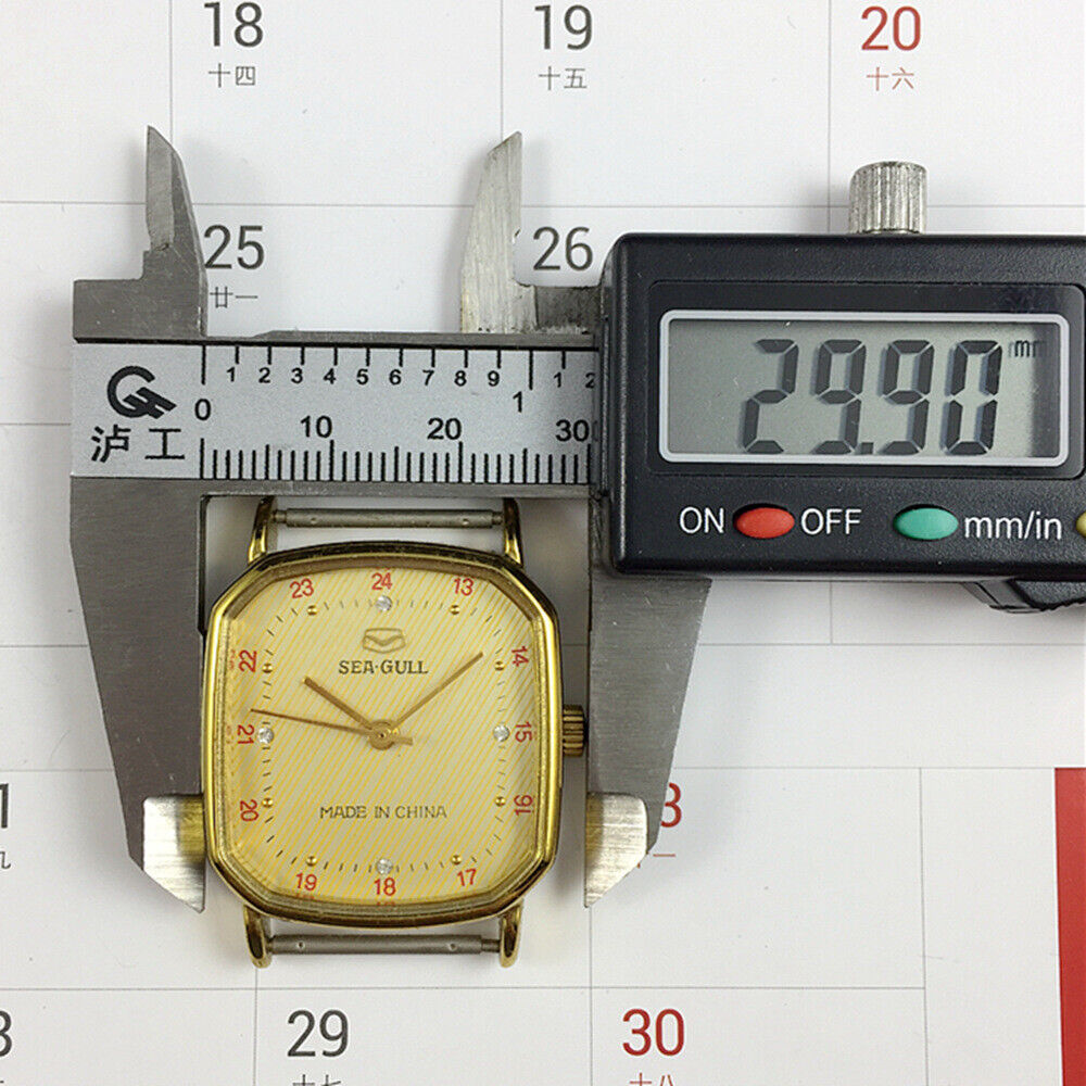 28mm Tianjin Seagull watch with golden octagonal case, manual movement, and elegant gold dial.