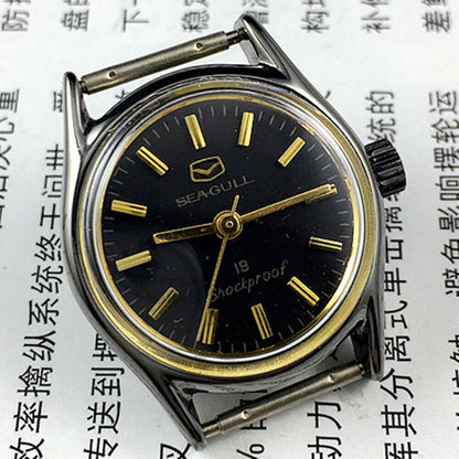 Black case Seagull ladies watch with golden hands, shock-resistant manual mechanical movement.