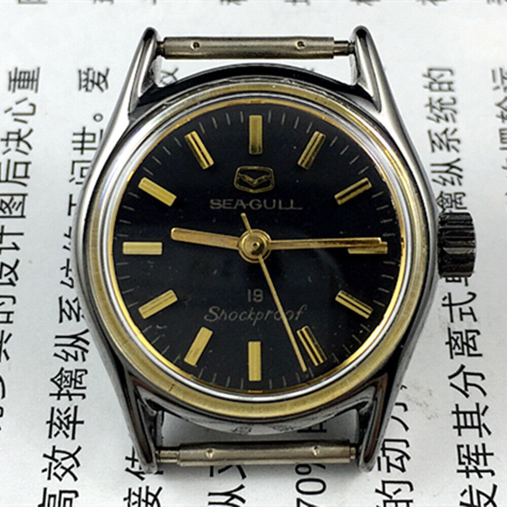 Seagull black case ladies watch with golden hands, shock-resistant manual mechanical movement for elegant timekeeping.