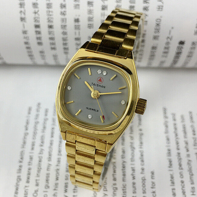 TAISHAN manual mechanical lady watch with 19 jewels, imitation diamond nails, and elegant golden case for stylish wear