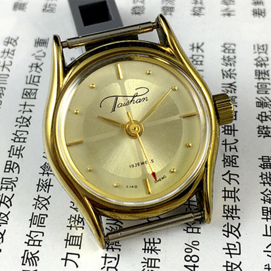 TAISHAN Lady mechanical watch with 19 jewels, champagne dial, and golden case, elegant timepiece design.