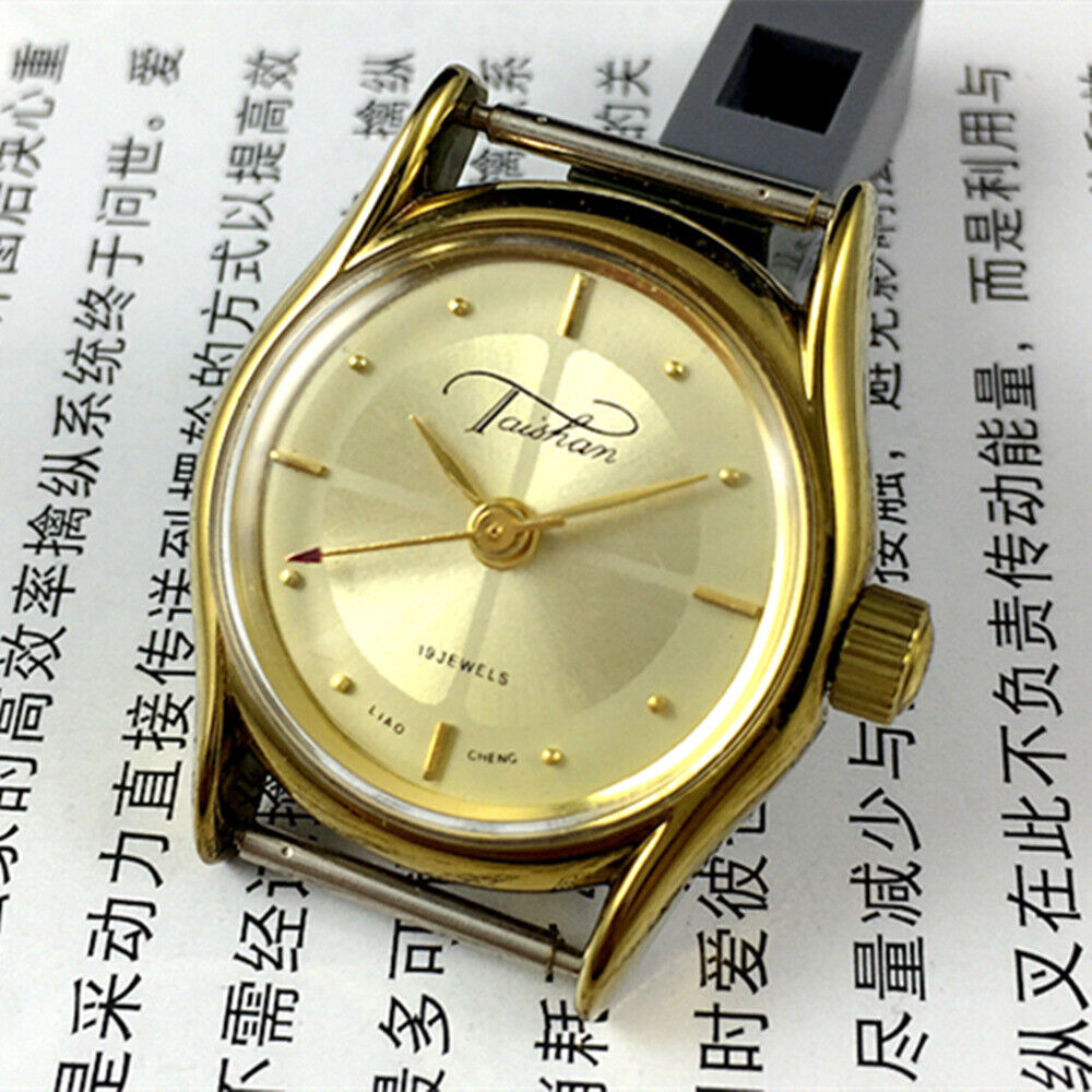 TAISHAN Lady watch with 19 jewels, champagne dial, and golden case, showcasing elegant mechanical design.