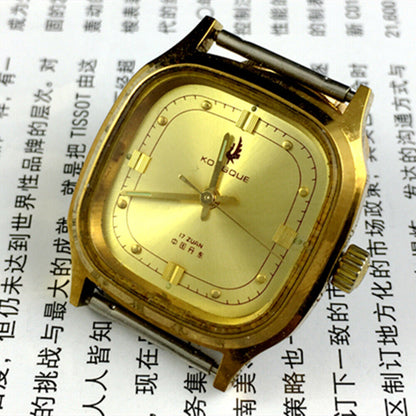 Dandong 33mm manual mechanical watch with 17 jewels, golden dial, square luxury case, and leather strap.
