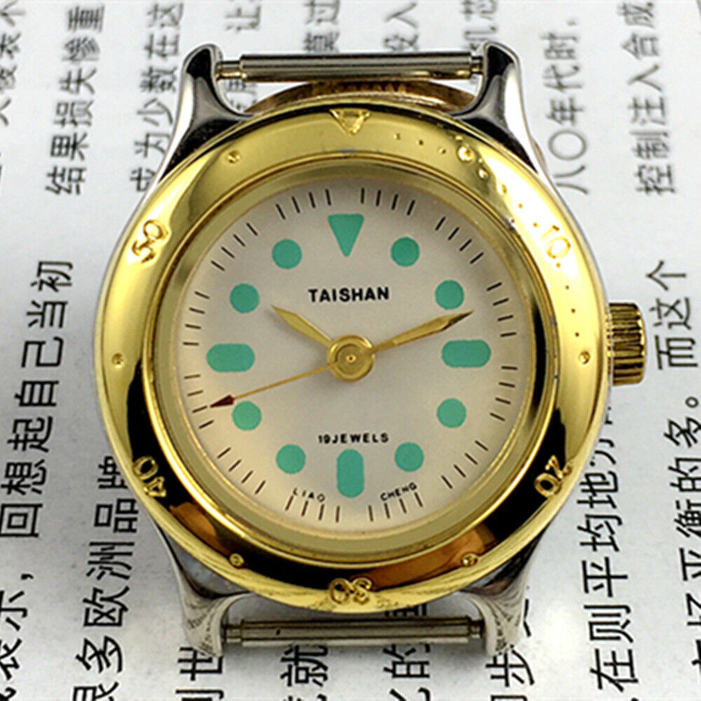 Elegant 28mm TAISHAN lady watch with golden case, numeric markers, manual mechanical movement, and 19 jewels.