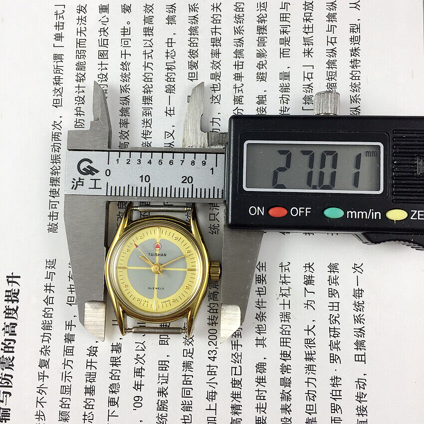 TAISHAN manual mechanical lady watch with 19 jewels, yellow-grey dial, and round gold case for elegant style.
