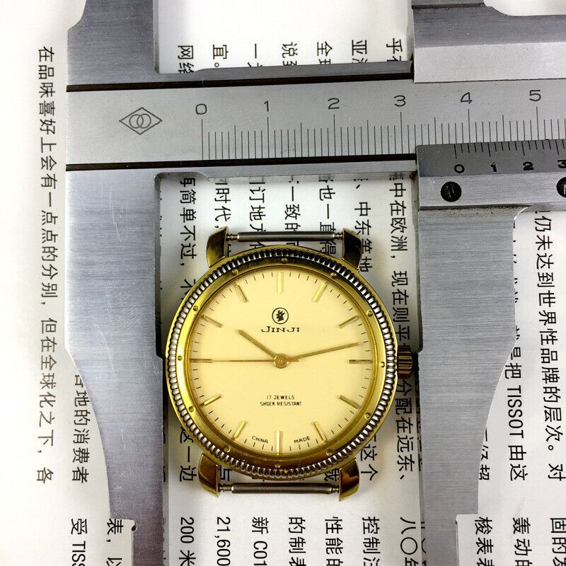 SHANGHAI JINJI 37mm manual mechanical watch with 17 jewels, shock resistance, and gold nail markers on a classic dial.