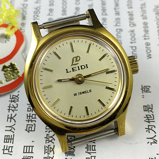 27mm Leidi Steel Lady Watch with golden dial and 18 jewels, paired with matching watch band for elegant style.