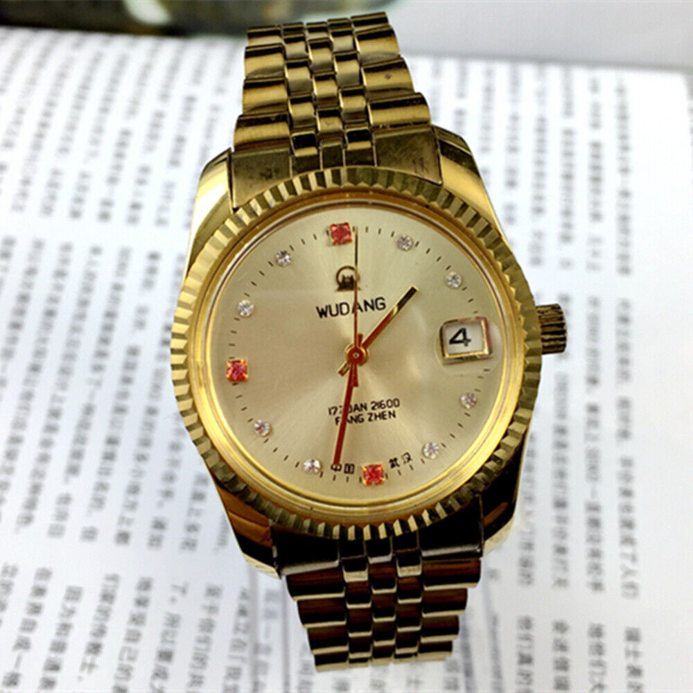 Wudang 38mm steel manual mechanical watch with 17 jewels, golden dial, and single calendar display.