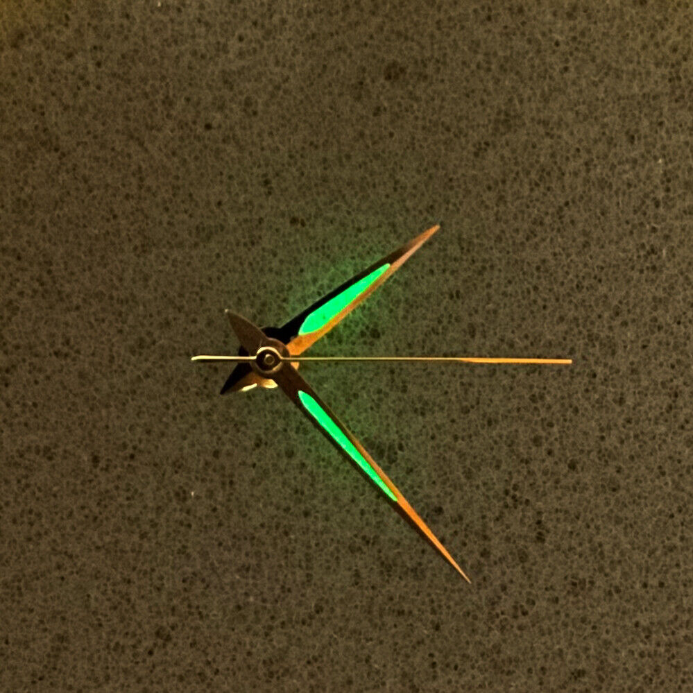Silver arrow-shaped luminous watch hands with green glow for NH35/NH36 movement, enhancing visibility and style.