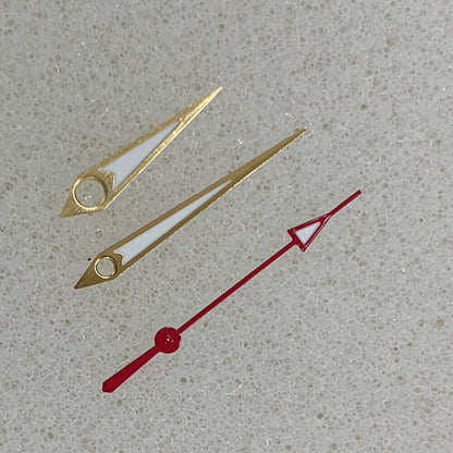 Golden arrow-shaped luminous watch hands with green trim, compatible with NH35/NH36/4R/7S movements, ideal for precise timekeeping.