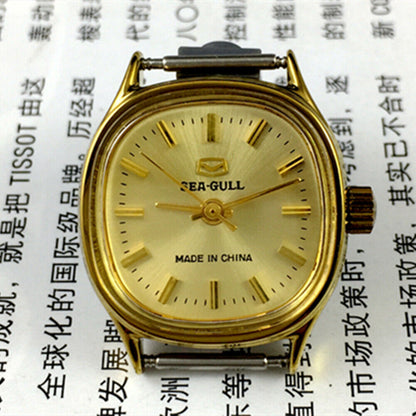 Golden dial Seagull ladies watch with nail hour markers, manual mechanical movement, elegant Tianjin brand design.