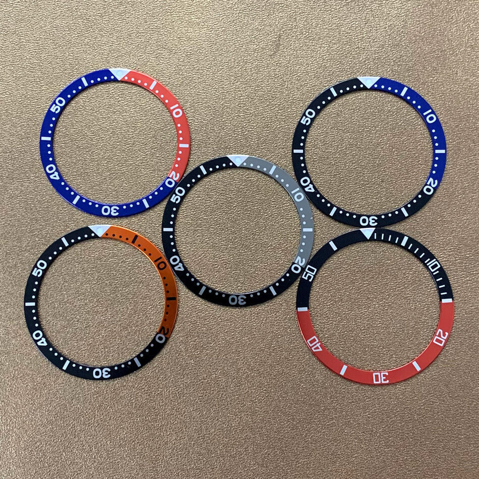 Red, blue, and black aluminum bezel insert for 39mm/32mm watch, enhancing style and durability.