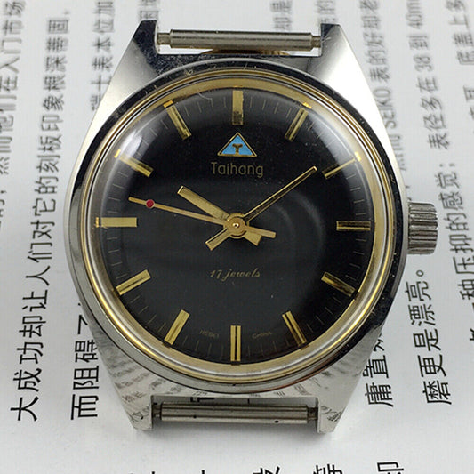 Black dial 32mm Taihang manual mechanical watch with golden nails, 17 jewels for precise timekeeping.