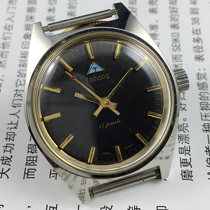 Black dial 32mm Taihang manual mechanical watch with gold markers, 17 jewels for accurate timekeeping.