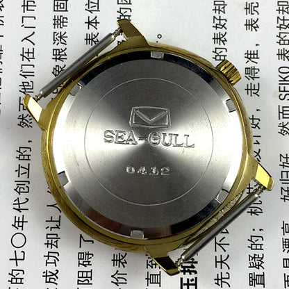 35mm Tianjin Seagull watch with golden round case and dial, manual mechanical movement, elegant design