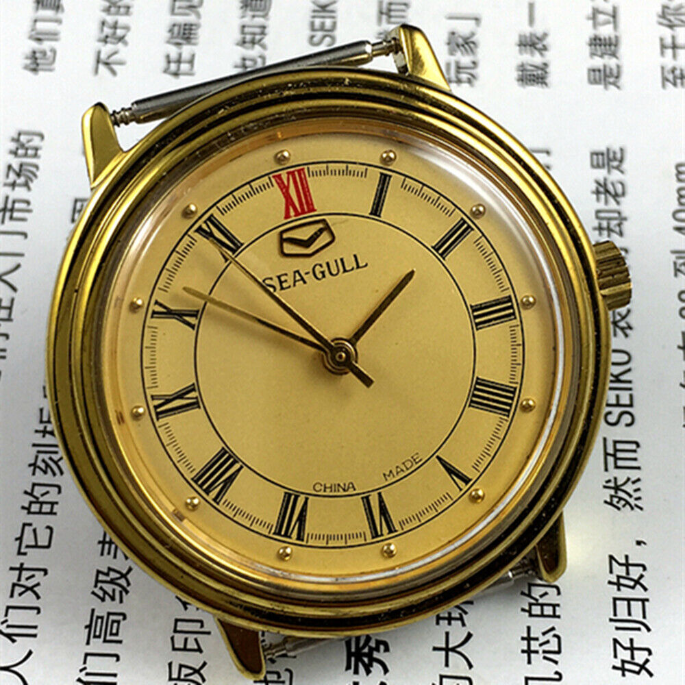 Tianjin Seagull 35mm watch with golden case, manual mechanical movement, elegant round dial design.
