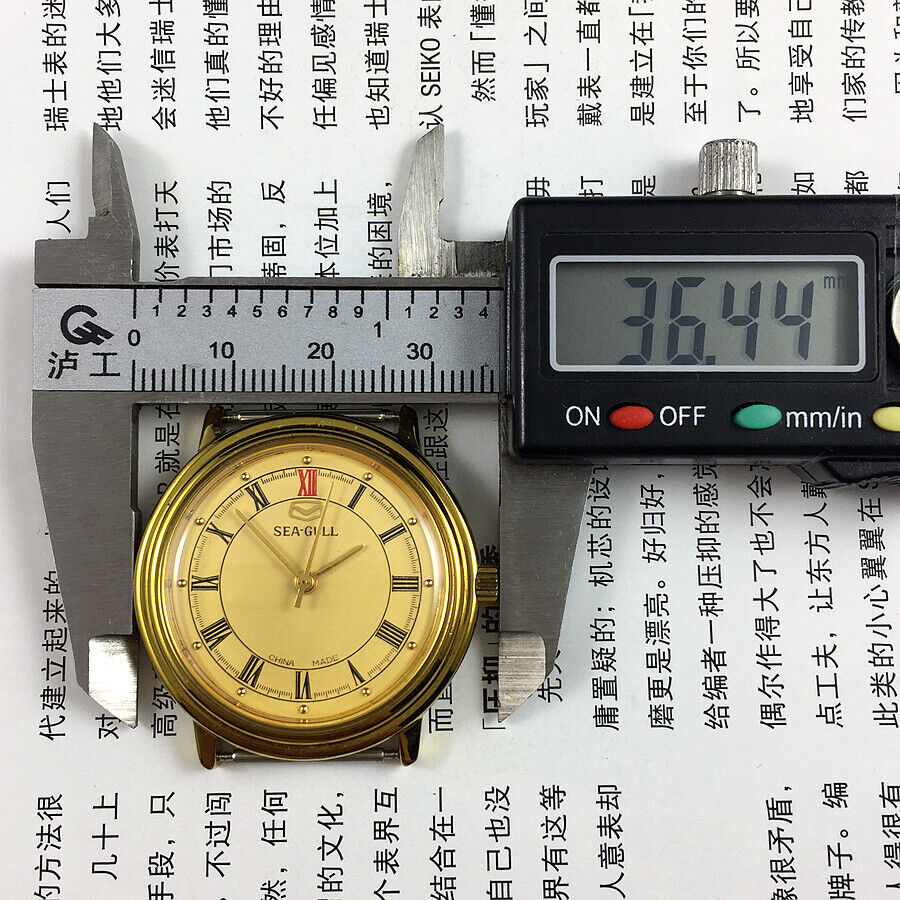35mm Tianjin Seagull watch with golden case, manual mechanical movement, and elegant dial design
