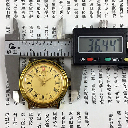35mm Tianjin Seagull watch with golden case, manual mechanical movement, and elegant dial design