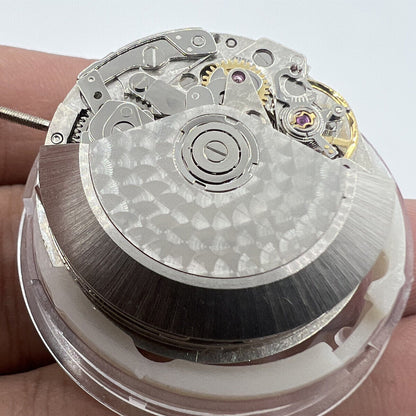 Close-up of Asian 7750 automatic chronograph movement by ETA, highlighting 3, 6, and 9 o'clock mechanism details.