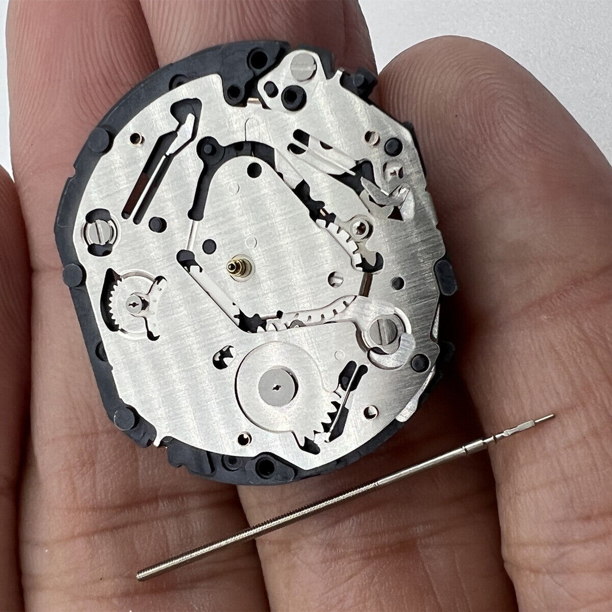Japan-made Hattori Epson TMI VX7J quartz watch movement with stem for precise timekeeping.