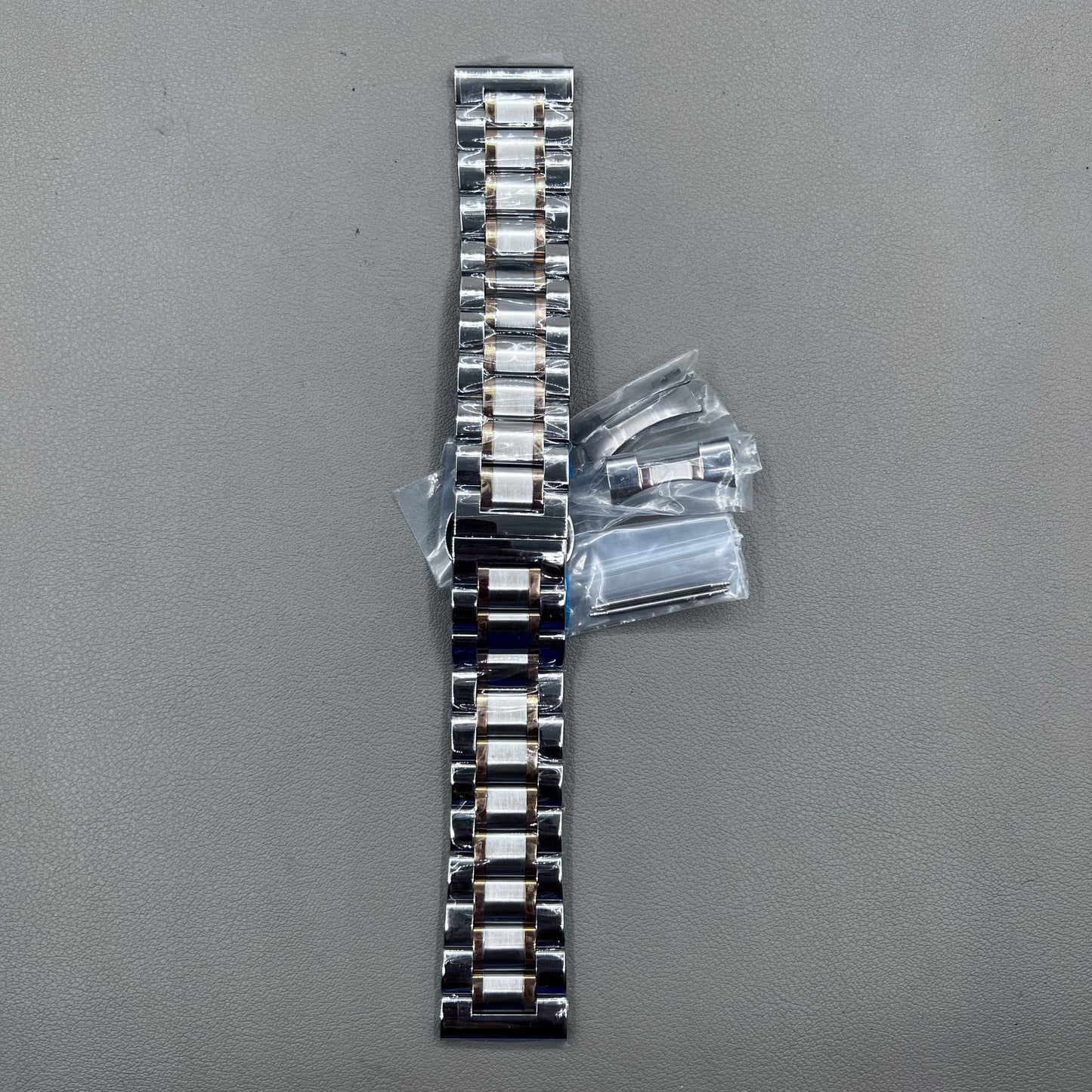 Curved end 12-24mm steel watch band strap in rose gold and silver with butterfly clasp.