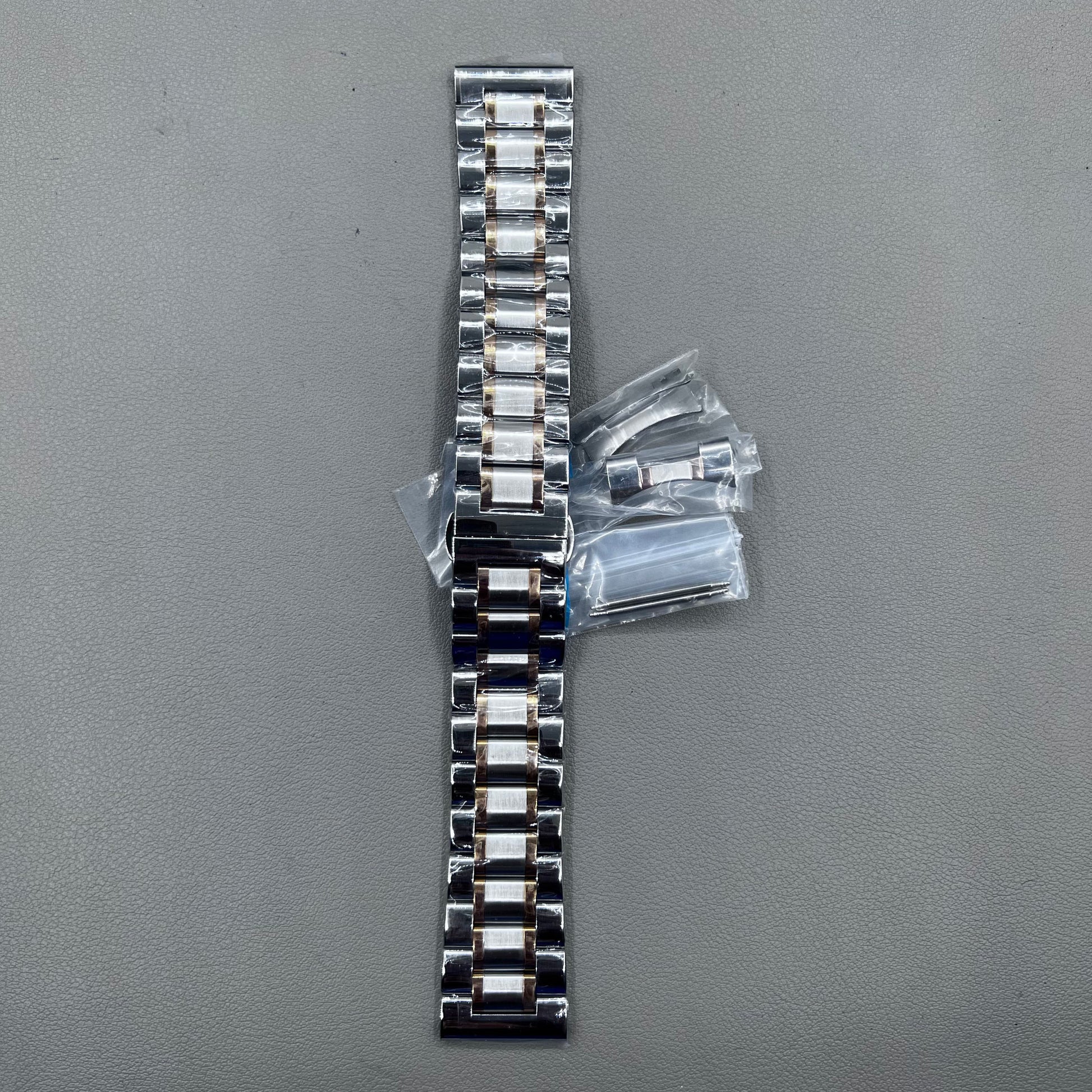 Curved end 12-24mm steel watch band strap in rose gold and silver with butterfly clasp.