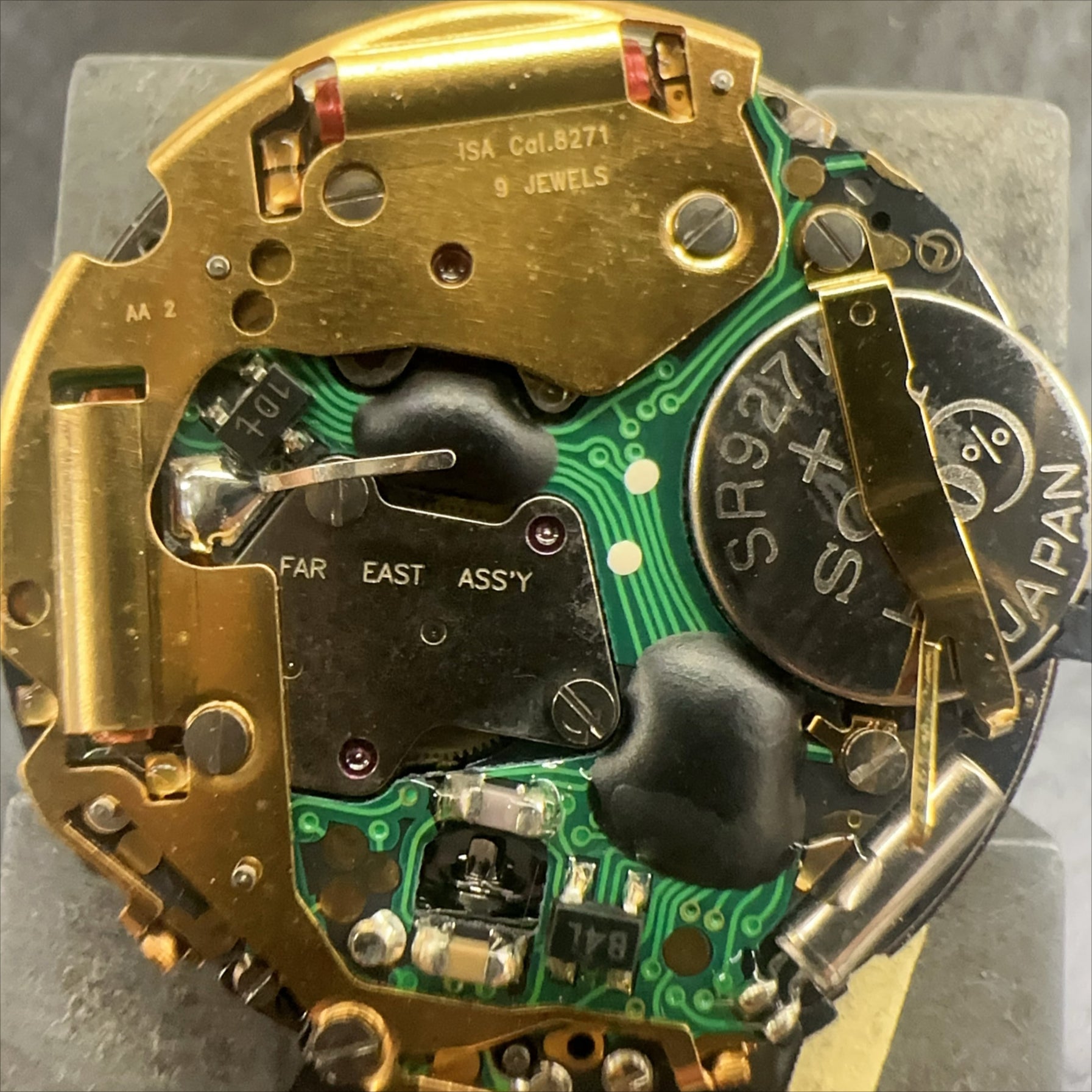 Swiss Made ISA 8271 watch part featuring black disk, multifunctional quartz movement for precision timekeeping.