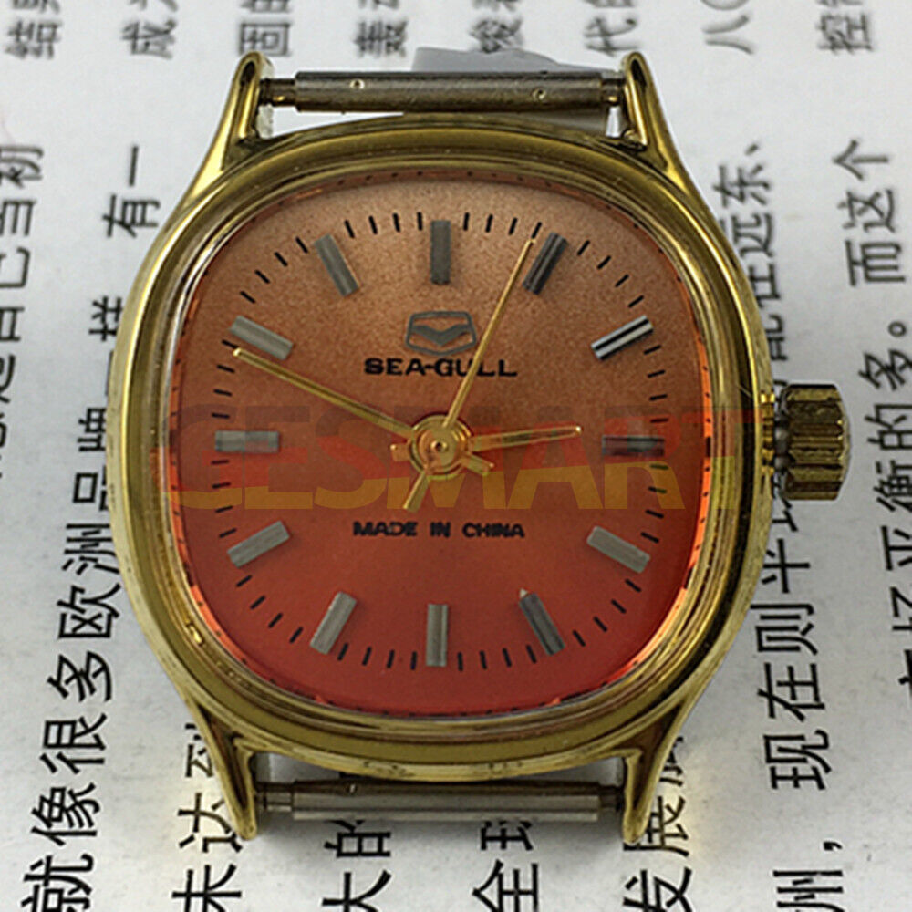 Seagull 27mm square gold watch with manual mechanical movement on vibrant orange background, elegant ladies accessory