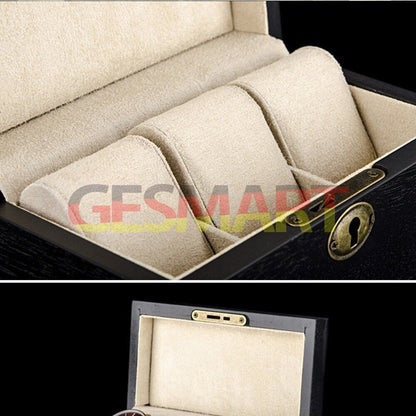Black wooden watch box organizer with three slots for elegant watch storage.