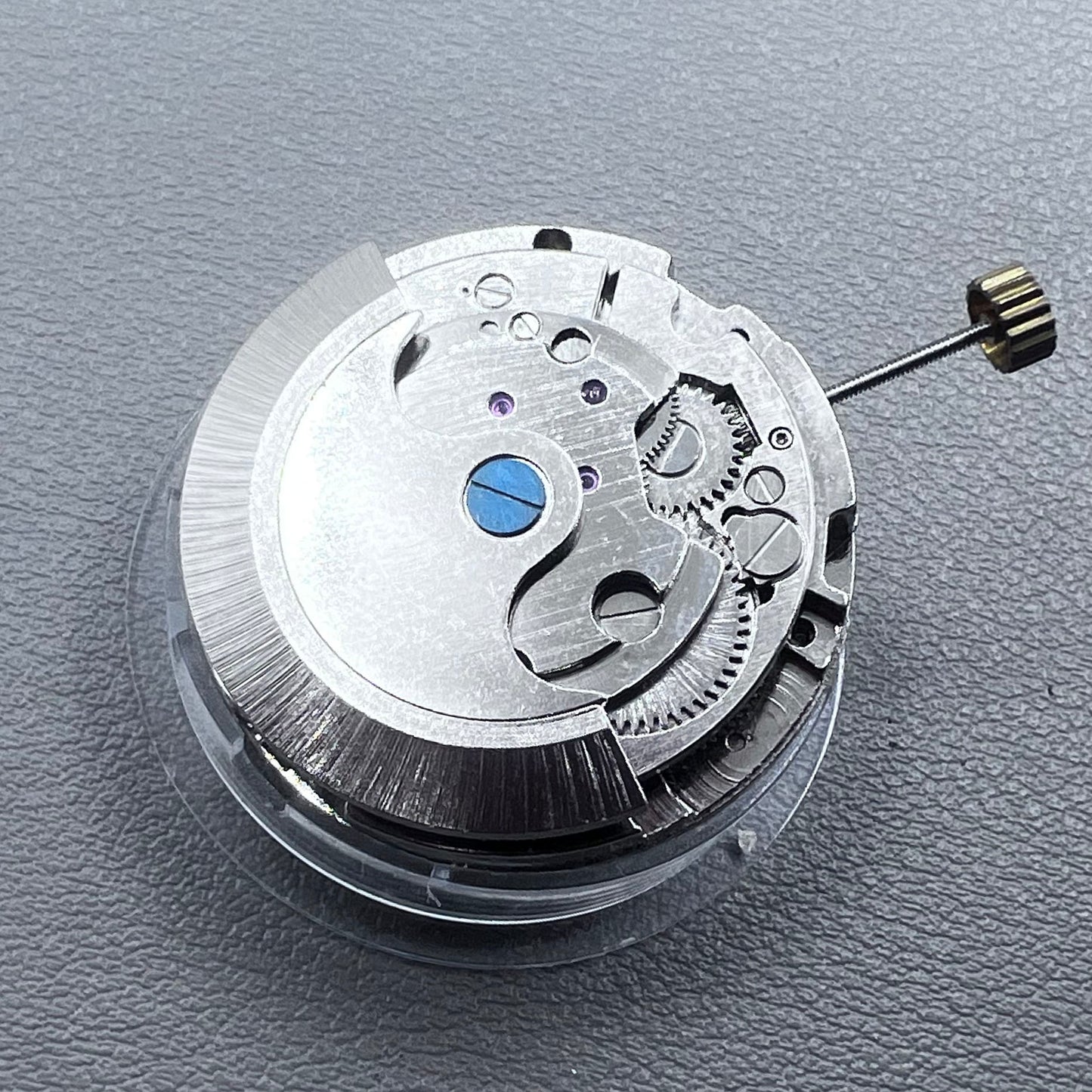 China multifunctional automatic watch with mechanical movement, moon phase at 12 o?clock, and visible flywheel detail