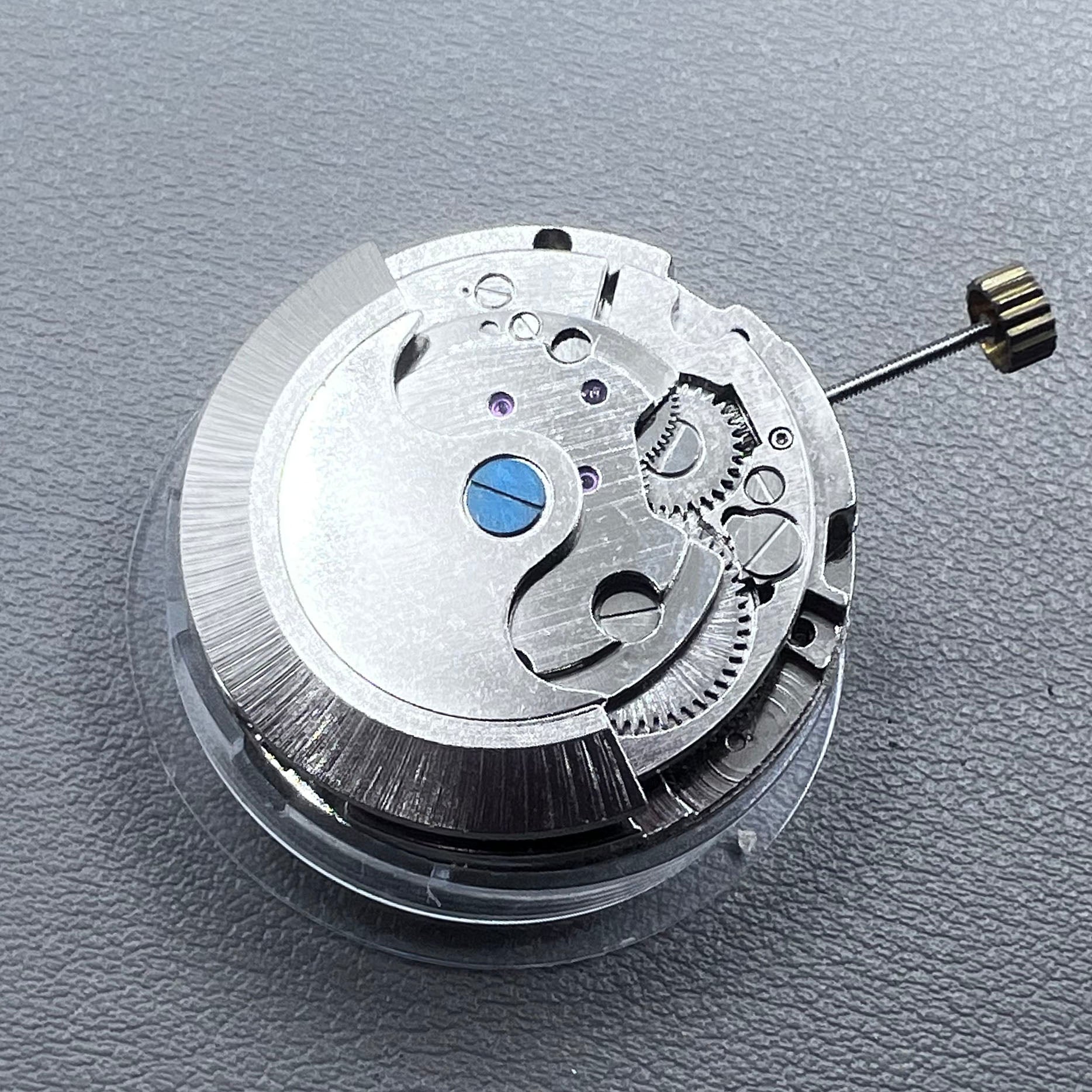 China multifunctional automatic watch with mechanical movement, moon phase at 12 o?clock, and visible flywheel detail
