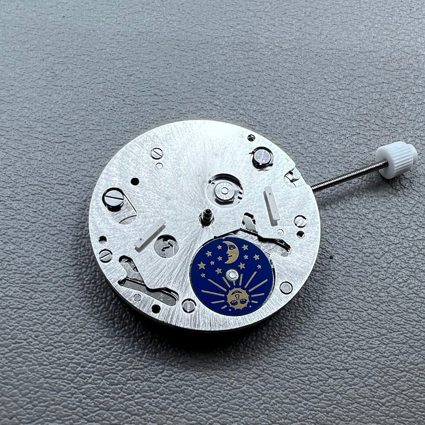 Swiss ISA 9231 Quartz watch movement with star moon phase display at 6 o'clock, precision craftsmanship.